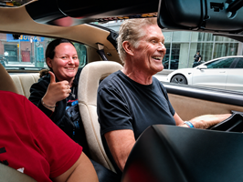David Hasselhoff smiling behind the wheel of KITT in downtown Toronto