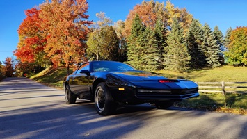 AGI KITT Knight Rider replica car parked in front of vibrant golden autumn foliage during October in Canada