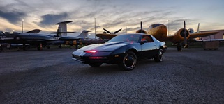 Pristine exterior profile of the KITT Knight Rider replica car highlighting the glossy black paint and classic 1983 Pontiac Trans Am body